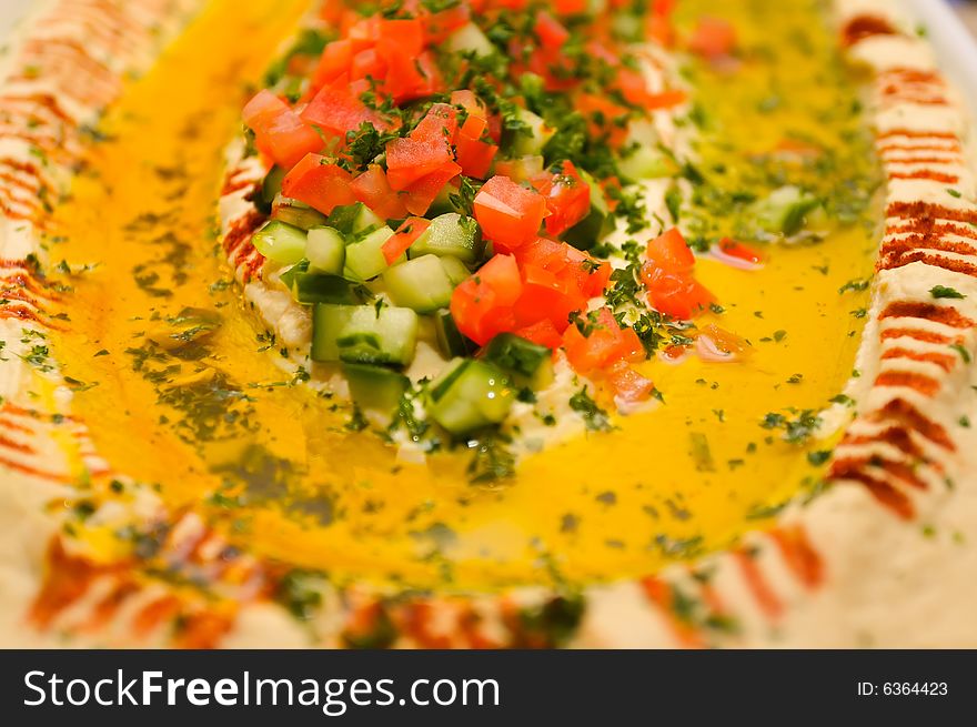 An image of cheesy hummus with vegetables