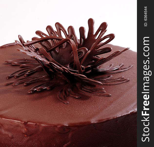 Chocolate cake in a square plate over white background