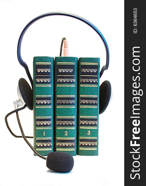 Three books with headphones over them. Three books with headphones over them