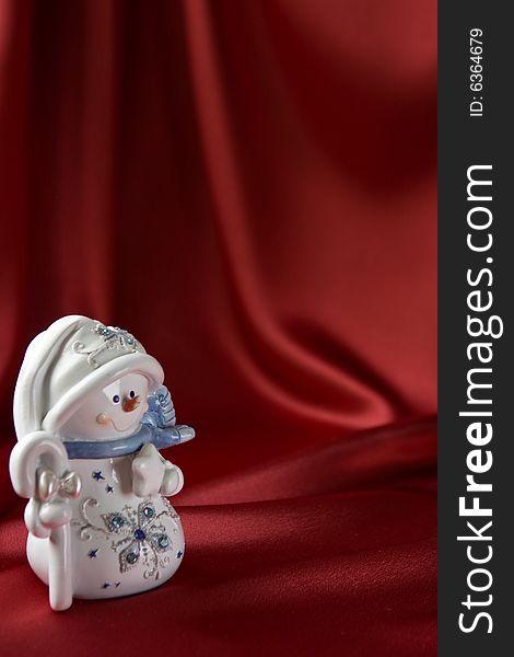 Snowman on red satin background