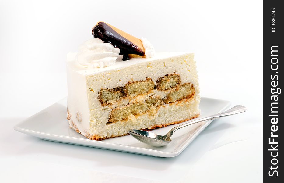 A view with a piece of cake over white background