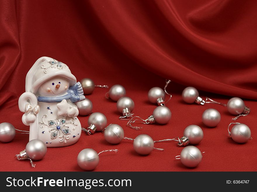 Snowman on red satin background. Snowman on red satin background
