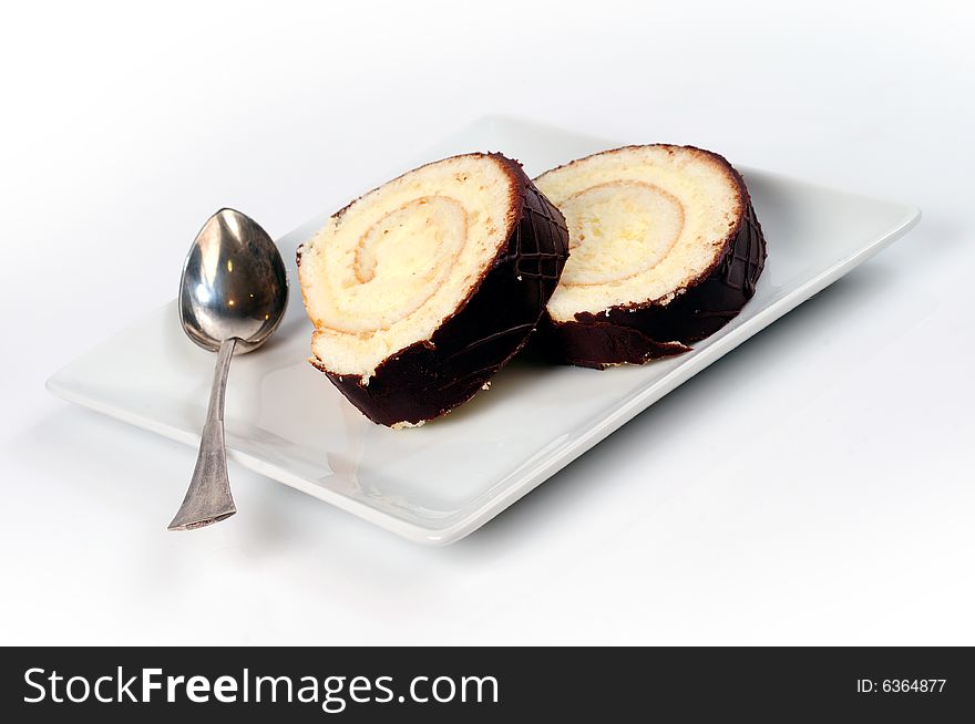 Chocolate cake in a square plate over white background