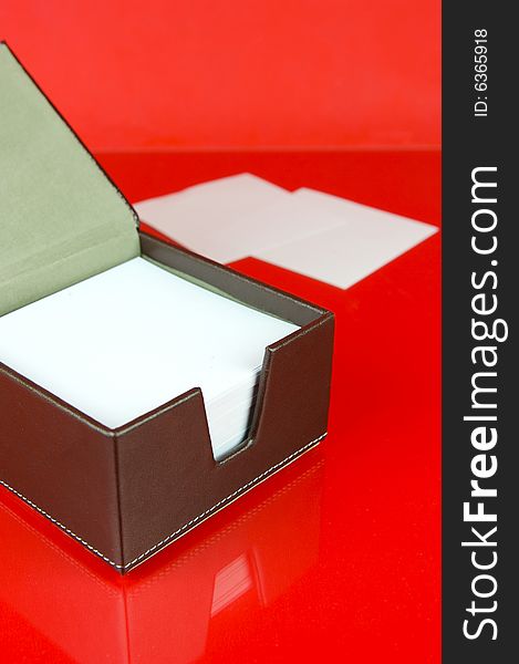 A note block isolated against a red background. A note block isolated against a red background