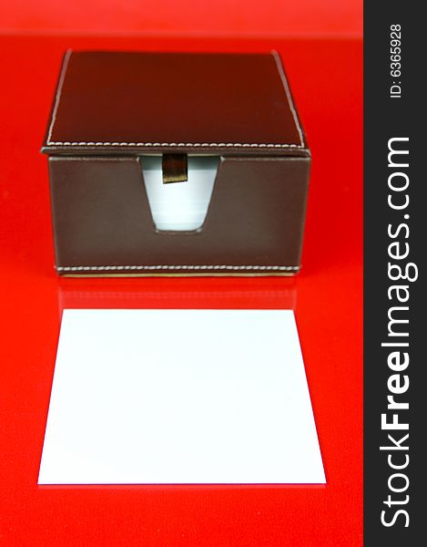 A note block isolated against a red background. A note block isolated against a red background