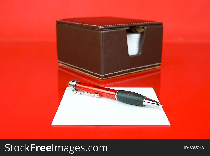 A note block isolated against a red background. A note block isolated against a red background