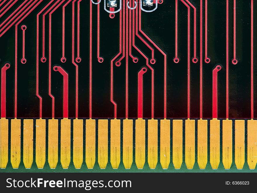 Red circuit board with yellow connector pins from a computer pwb. Red circuit board with yellow connector pins from a computer pwb