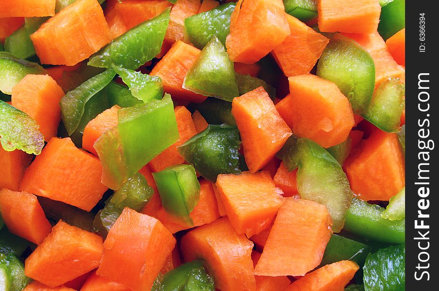 Close-up of chopped carrot and green pepper. Close-up of chopped carrot and green pepper