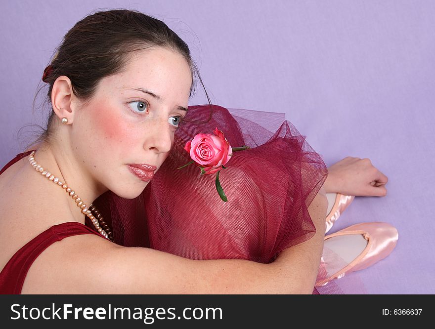 Teenage ballet dancer in a burgundy costume. Teenage ballet dancer in a burgundy costume