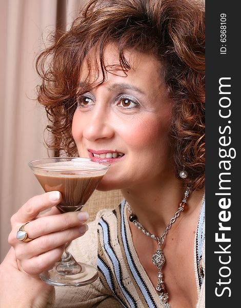 Mature female with a chocolate drink in her hand