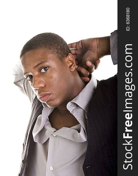 A young black man in grey and black with his hands behind his head in a casual pose. A young black man in grey and black with his hands behind his head in a casual pose