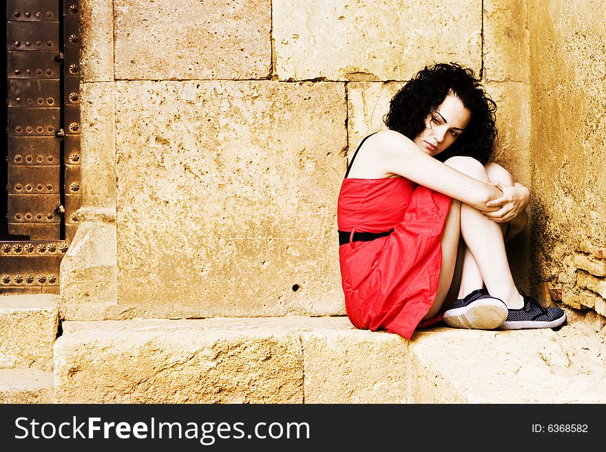 Young beautiful lone woman on red dress. Young beautiful lone woman on red dress