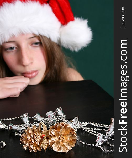 Brunette Teenager wearing a christmas hat. FOCUS ON DECORATIONS