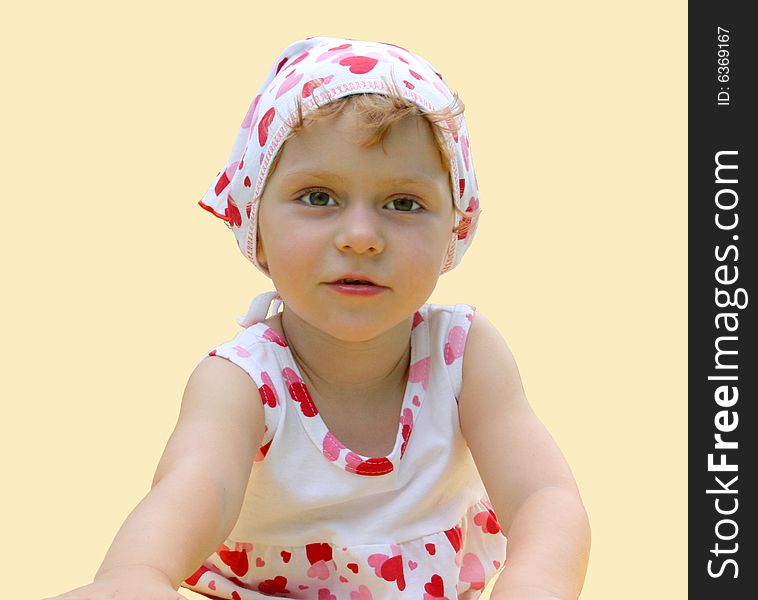 A little girl lies on the floor. a child is isolated on a yellow background