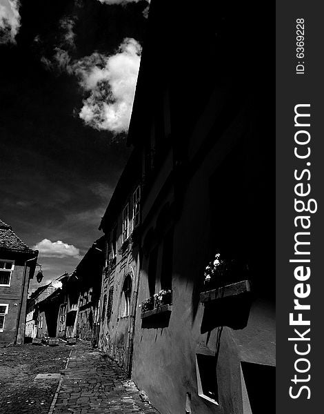 A nice little street in Romania caught my eye that beautiful day. The shadow and light go's great with the cloud in the sky. A nice little street in Romania caught my eye that beautiful day. The shadow and light go's great with the cloud in the sky.