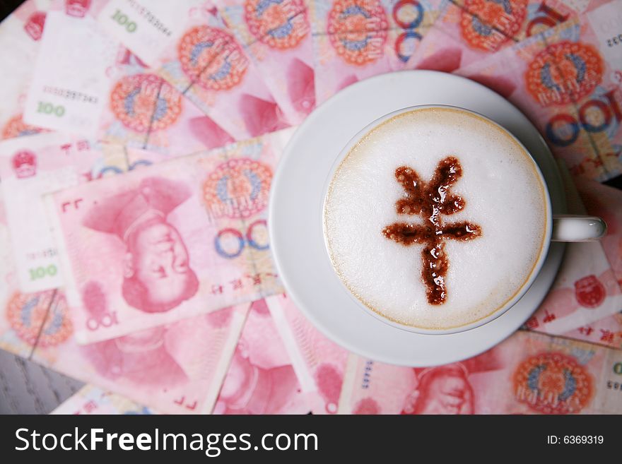 Cup of cappucino with RMB sign on money(RMB)