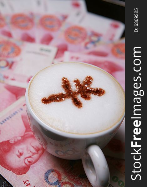 Cup of cappucino with RMB sign on money(RMB)