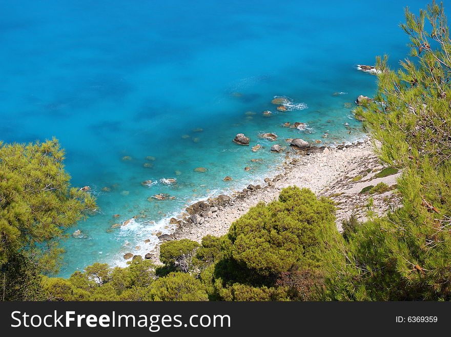 Turquoise and blue waters at the western coast of Lefkada island (Pefkakia area), at the Ionian sea, Greece. Turquoise and blue waters at the western coast of Lefkada island (Pefkakia area), at the Ionian sea, Greece