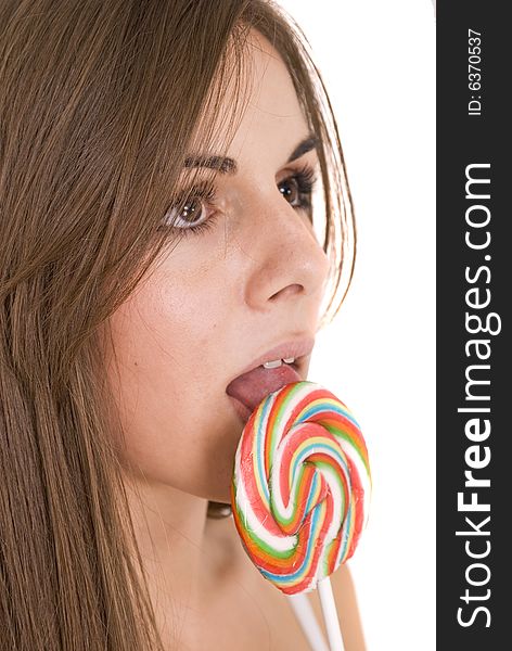 Girl licking her lollipop isolated on white