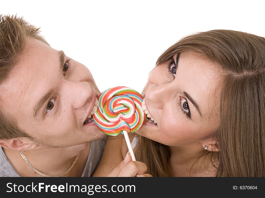 Girl and a guy licking lollipop together