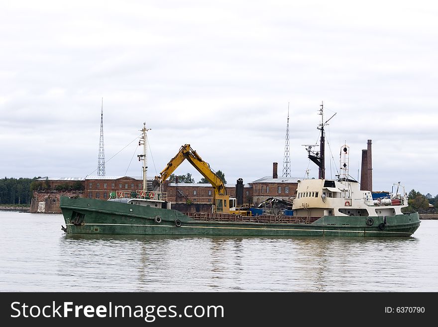 A power shovel in operation on a barge