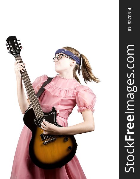 Young girl in a pink dress with an electric rock guitar. Young girl in a pink dress with an electric rock guitar