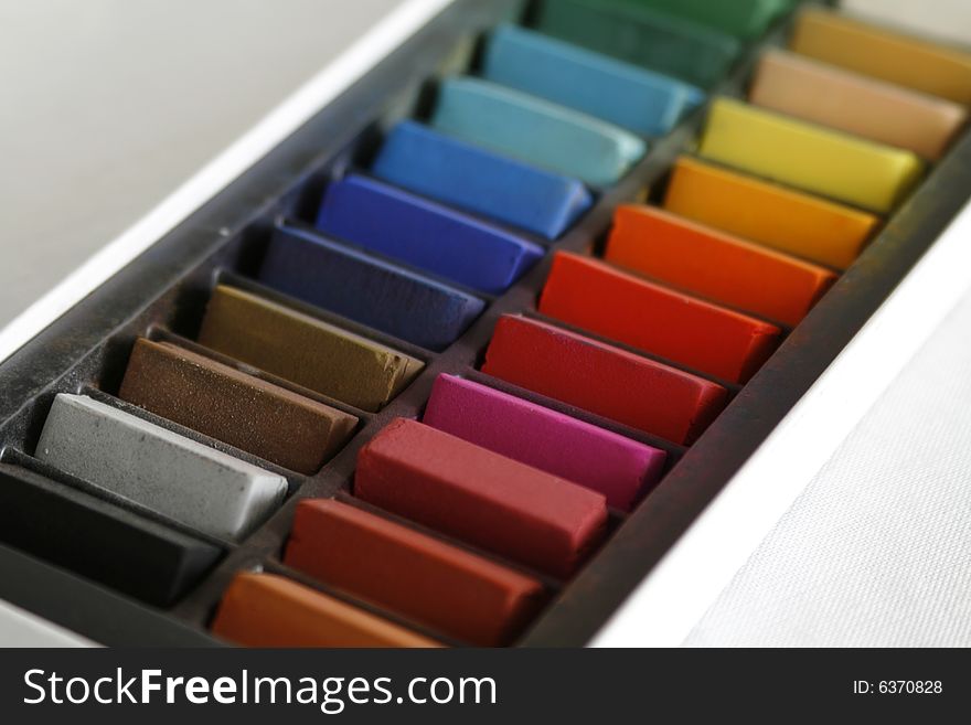 Close up of coloured pastels in a box