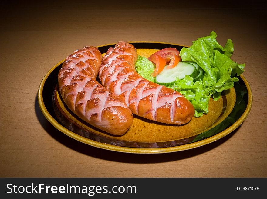 Sausages on plate with tomatoes. Sausages on plate with tomatoes