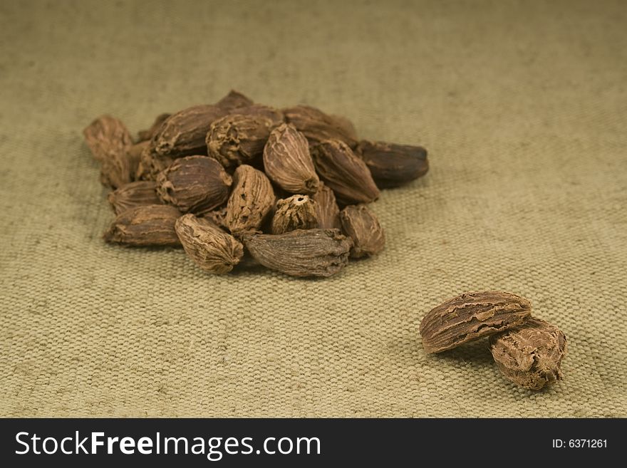 Black cardamom fruits on burlap