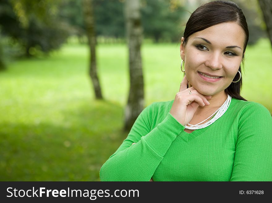 Attractive brunette woman in park. Attractive brunette woman in park