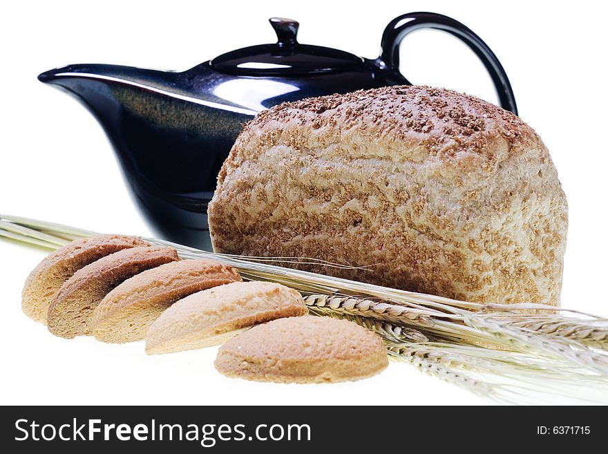 Pastry, wheat, bread and teapot on white. Pastry, wheat, bread and teapot on white