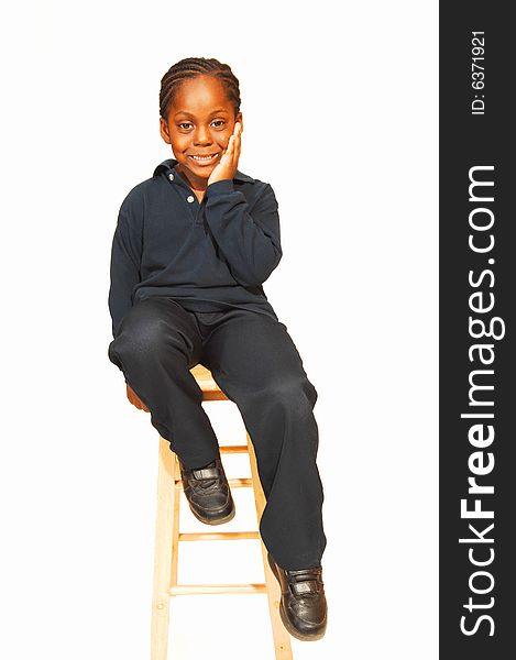 A friendly young Jamaican boy in the studio sitting on an bar chair and 
wondering what is going on around him. A friendly young Jamaican boy in the studio sitting on an bar chair and 
wondering what is going on around him.