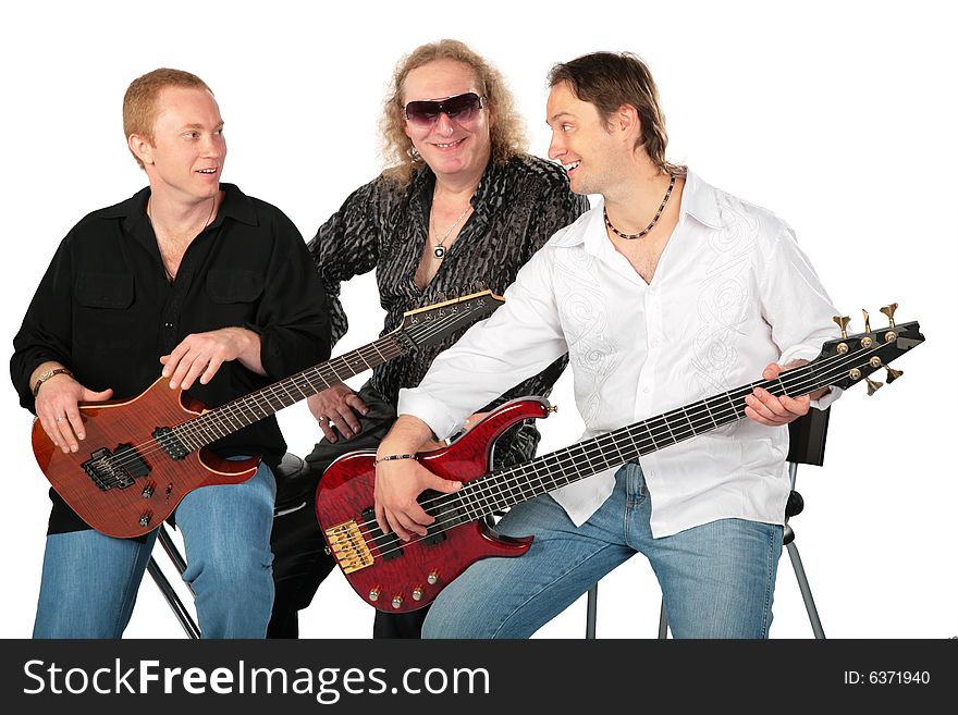 Three Sitting Men With Two Guitars. Talking Music