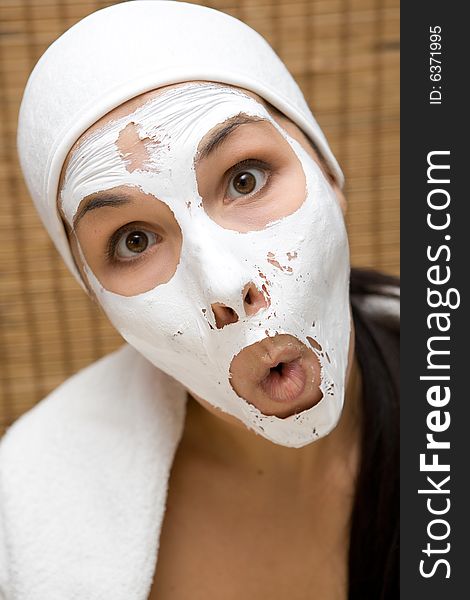 Attractive brunette woman with facial mask