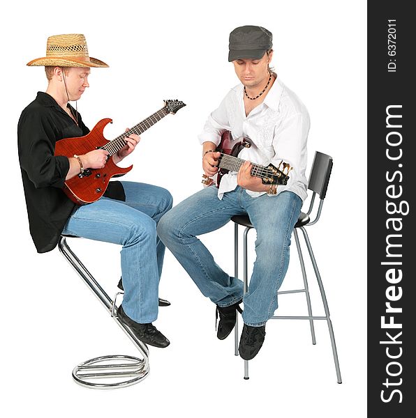 Two sitting men in hats play on guitars on white. Two sitting men in hats play on guitars on white