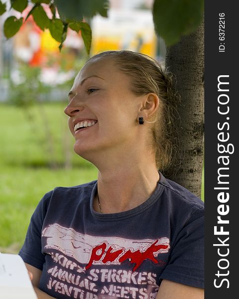 Portrait of laughing woman under the tree