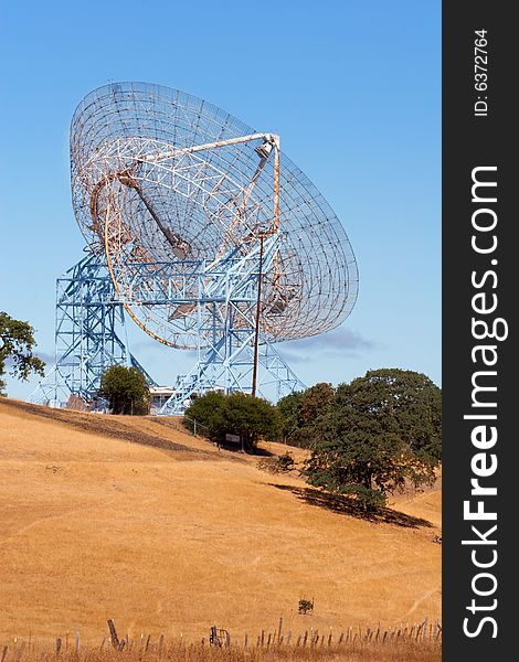 A view of the Stanford radio telescope, or 'dish', in the Stanford Foothills, Palo Alto, CA.  Vertical, shot during the summer, with field prominant. A view of the Stanford radio telescope, or 'dish', in the Stanford Foothills, Palo Alto, CA.  Vertical, shot during the summer, with field prominant.