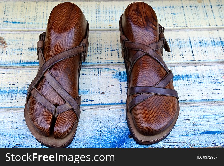 Leather sandals on wooden boot-tree