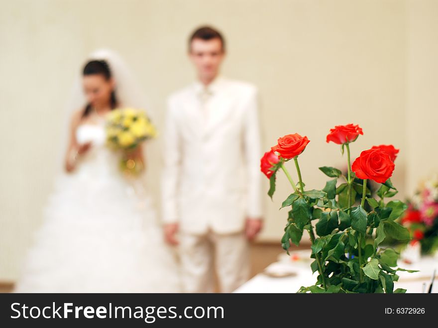 Bunch of white roses and newly-weds on a background. Bunch of white roses and newly-weds on a background