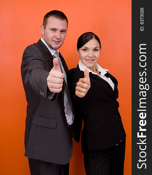 Woman and man in team standing on orange background. Woman and man in team standing on orange background