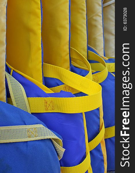 Row of life jackets on marina
