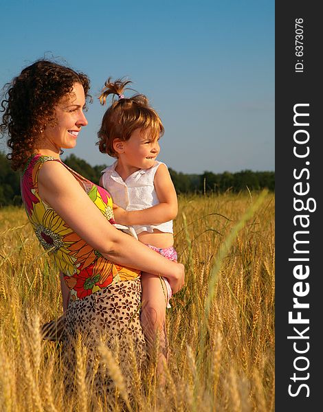 Mother with  child on a wheaten field