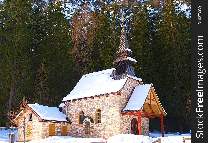 A wondeful shot of a little church on the frozen lake of Braies n Dolomiti mountains