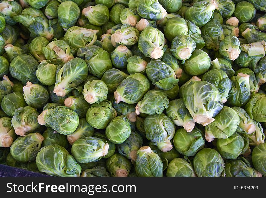 A bin full of fresh brussel sprouts at a local farmers' market