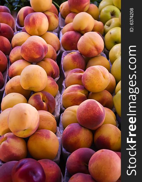 Bins of fresh peaches at a local farmers' marker.