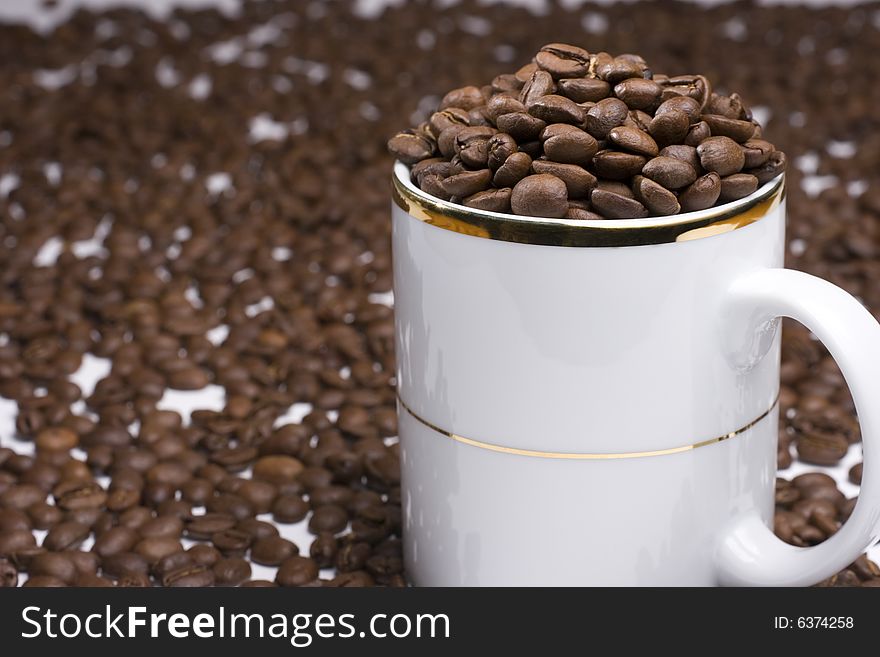 White coffee cup with many coffee beans. White coffee cup with many coffee beans