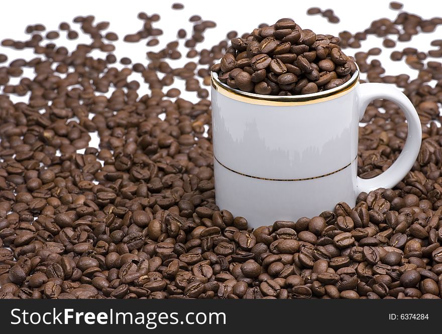 White coffee cup with many coffee beans. White coffee cup with many coffee beans