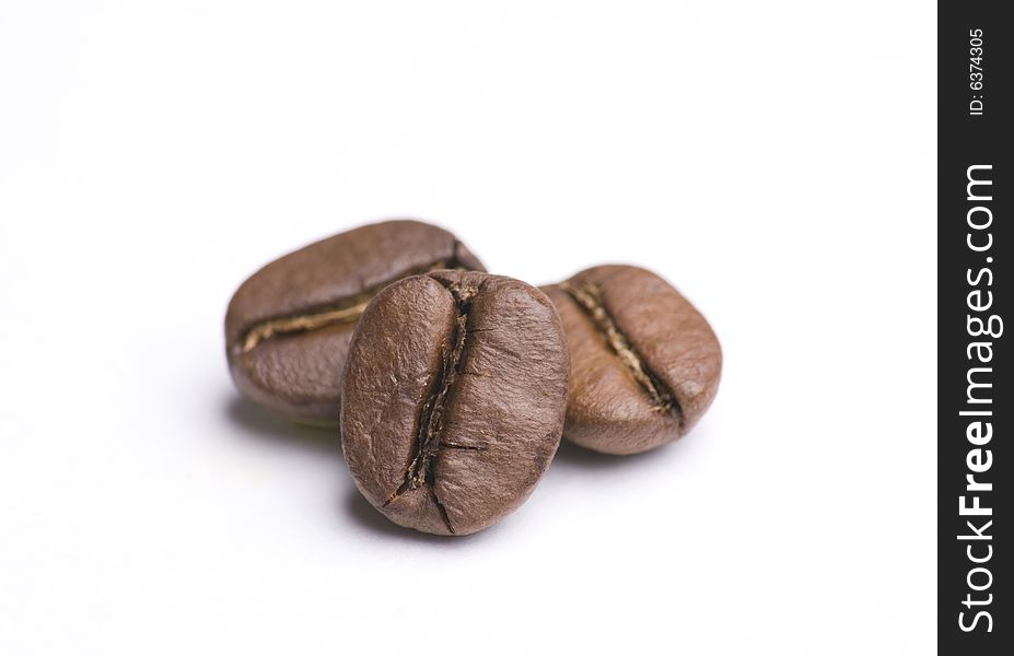Close up of three coffee beans on white background. Close up of three coffee beans on white background