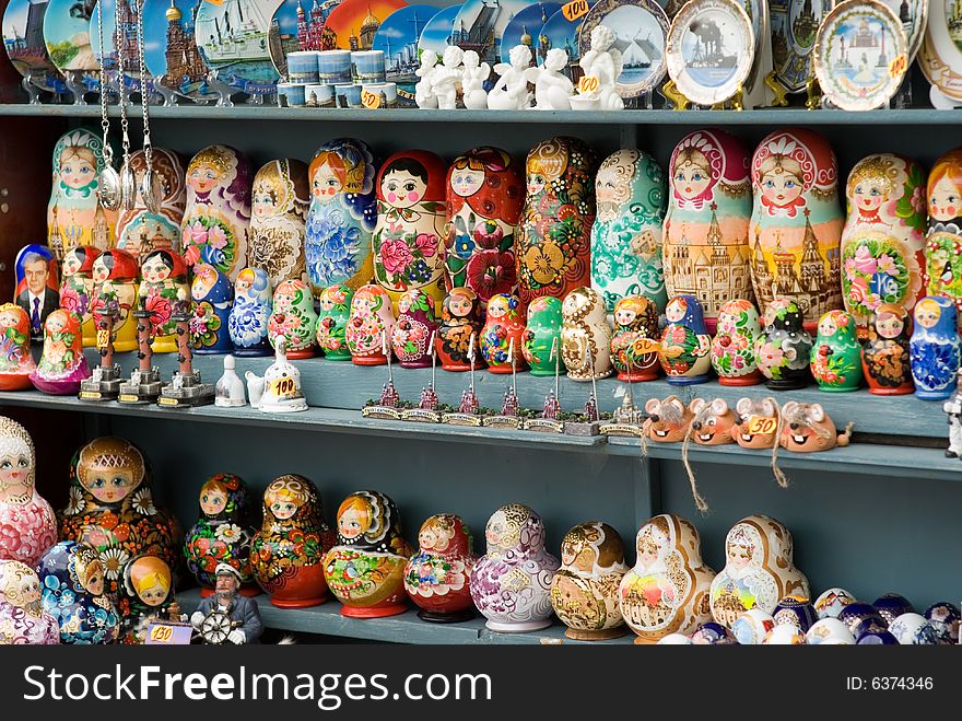 Shelf with souvenirs nested dolls and plates