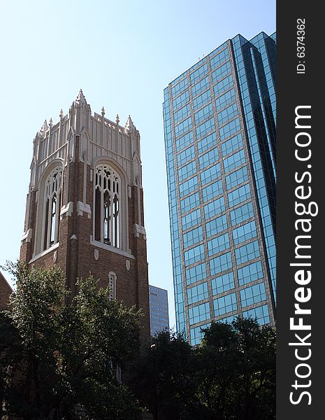 A modern skyscraper stands next to a traditional church bell tower. A modern skyscraper stands next to a traditional church bell tower.